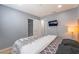 Bedroom features a wall-mounted TV, lamp, and access to a closet at 1012 Greystone Dr, Las Vegas, NV 89108