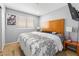 Bedroom with headboard, TV, side tables with lamps, and patterned bedding at 1012 Greystone Dr, Las Vegas, NV 89108