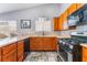 Kitchen with wooden cabinets, stainless steel appliances, and tile flooring at 1012 Greystone Dr, Las Vegas, NV 89108