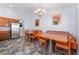 Kitchen with stainless steel refrigerator and breakfast nook with two tables and built in seating at 1012 Greystone Dr, Las Vegas, NV 89108