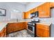 Kitchen featuring wooden cabinets, stainless steel appliances, and tile flooring at 1012 Greystone Dr, Las Vegas, NV 89108