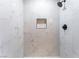 Modern shower featuring black fixtures and white marble-patterned tile at 1012 Greystone Dr, Las Vegas, NV 89108
