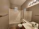 This bathroom features a vanity with storage, tiled flooring and a shower over tub combination at 10231 Deerfield Beach Ave # 104, Las Vegas, NV 89129