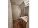 Cozy powder room showcasing a wood vanity, a framed mirror, and neutral walls at 10231 Deerfield Beach Ave # 104, Las Vegas, NV 89129