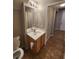 Compact bathroom featuring a wood vanity, an expansive mirror, and seamless flooring at 10231 Deerfield Beach Ave # 104, Las Vegas, NV 89129