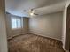 Bedroom with neutral paint, carpet, ceiling fan, and window with blinds at 10231 Deerfield Beach Ave # 104, Las Vegas, NV 89129