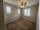 Bedroom with neutral paint, carpet, and three windows with blinds at 10231 Deerfield Beach Ave # 104, Las Vegas, NV 89129