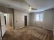 Spacious bedroom with carpet, ceiling fan, walk-in closet, and natural light at 10231 Deerfield Beach Ave # 104, Las Vegas, NV 89129