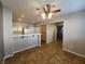Open dining room featuring tile floors, a ceiling fan, and seamless access to the kitchen and other living spaces at 10231 Deerfield Beach Ave # 104, Las Vegas, NV 89129