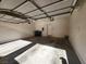 Inside the garage, revealing a 2-car capacity, overhead door, and essential utility connections at 10231 Deerfield Beach Ave # 104, Las Vegas, NV 89129