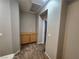 Hallway with carpet, built-in cabinets, and doorway to the next room at 10231 Deerfield Beach Ave # 104, Las Vegas, NV 89129