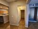 Open-concept living area with tile flooring and view into the kitchen at 10231 Deerfield Beach Ave # 104, Las Vegas, NV 89129