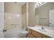 This well-lit bathroom has a tub-shower combo, and a vanity sink with a mirror at 10305 Snyder Ave, Las Vegas, NV 89134