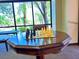 Features a chess set on a wooden game table with abundant natural light through large windows at 10305 Snyder Ave, Las Vegas, NV 89134