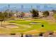 Scenic golf course view with lush green fairways, mature trees, sand traps, and a glimpse of the city skyline in the background at 10305 Snyder Ave, Las Vegas, NV 89134