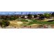 Picturesque view of a manicured golf course, showcasing lush fairways, sand traps, and the city skyline in the distance at 10305 Snyder Ave, Las Vegas, NV 89134