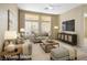 Bright living room with large windows, neutral decor, and comfortable seating at 10305 Snyder Ave, Las Vegas, NV 89134