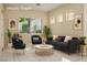 Stylish living room with modern furniture and natural light from a large window at 10305 Snyder Ave, Las Vegas, NV 89134