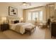 Serene bedroom with a bay window, neutral colors, and comfortable furnishings at 10305 Snyder Ave, Las Vegas, NV 89134