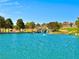 Scenic pond with a waterfall feature, surrounded by trees and lush landscaping, offering a tranquil setting at 10305 Snyder Ave, Las Vegas, NV 89134