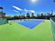 Well-maintained tennis court surrounded by lush greenery, perfect for an active lifestyle at 10305 Snyder Ave, Las Vegas, NV 89134