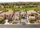 Expansive aerial view of a home and neighborhood featuring a golf course and mountain views at 11453 Glowing Sunset Ln, Las Vegas, NV 89135