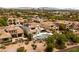 Home aerial view featuring a pool, spa, and lush landscaping in a desert setting at 11453 Glowing Sunset Ln, Las Vegas, NV 89135