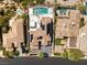 Aerial shot showcasing the home's tile roof, solar panels, and luxurious pool at 11453 Glowing Sunset Ln, Las Vegas, NV 89135
