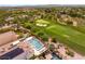 Property aerial view featuring a pool, golf course view, and lush landscaping at 11453 Glowing Sunset Ln, Las Vegas, NV 89135