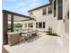 Backyard with an outdoor kitchen and tile patio with bar seating at 11453 Glowing Sunset Ln, Las Vegas, NV 89135