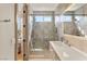 Modern bathroom with a glass shower, sleek vanity, and light gray tiling at 11453 Glowing Sunset Ln, Las Vegas, NV 89135