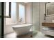 Bright bathroom with contemporary fixtures, soaking tub and glass shower at 11453 Glowing Sunset Ln, Las Vegas, NV 89135