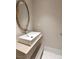 Modern bathroom featuring a stylish rectangular sink, wood-framed mirror, and neutral color palette at 11453 Glowing Sunset Ln, Las Vegas, NV 89135