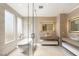 Luxurious bathroom with soaking tub, natural light, and dual floating vanities at 11453 Glowing Sunset Ln, Las Vegas, NV 89135