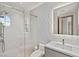 Bright bathroom featuring a glass shower with a unique round window and modern vanity at 11453 Glowing Sunset Ln, Las Vegas, NV 89135