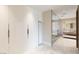 Modern primary bathroom with sleek, white vanities and glass enclosed shower at 11453 Glowing Sunset Ln, Las Vegas, NV 89135