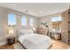 Cozy bedroom with wood floors, arched windows, and neutral color scheme at 11453 Glowing Sunset Ln, Las Vegas, NV 89135