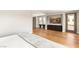 Bedroom showcasing hardwood floors, a mounted TV, and balcony access, blending comfort and style at 11453 Glowing Sunset Ln, Las Vegas, NV 89135
