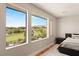 Serene bedroom showcasing large windows with views of a lush golf course at 11453 Glowing Sunset Ln, Las Vegas, NV 89135