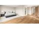 Modern bedroom features hardwood floors, neutral walls, and a comfortable king-size bed with nightstands at 11453 Glowing Sunset Ln, Las Vegas, NV 89135
