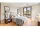 Elegant bedroom with wood floors, balcony access, and neutral decor at 11453 Glowing Sunset Ln, Las Vegas, NV 89135