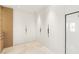Modern closet with white cabinets, black hardware and marble flooring at 11453 Glowing Sunset Ln, Las Vegas, NV 89135