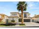 Beautiful two-story home with a tile roof, attached garages, and professional landscaping at 11453 Glowing Sunset Ln, Las Vegas, NV 89135