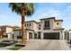 Inviting two-story home with tile roof, attached garages and modern design at 11453 Glowing Sunset Ln, Las Vegas, NV 89135