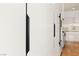 Close-up of sleek, modern white kitchen cabinets with black hardware at 11453 Glowing Sunset Ln, Las Vegas, NV 89135