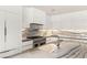 Well-appointed kitchen with marble countertops, custom backsplash, and stainless appliances at 11453 Glowing Sunset Ln, Las Vegas, NV 89135