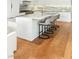 Close up of kitchen island with marble countertop and waterfall edge at 11453 Glowing Sunset Ln, Las Vegas, NV 89135