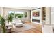 Well-lit living room with hardwood floors, white sofa, and a sleek fireplace at 11453 Glowing Sunset Ln, Las Vegas, NV 89135