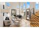 Bright living room with soaring ceilings, a grand piano, and a modern staircase with metal railings at 11453 Glowing Sunset Ln, Las Vegas, NV 89135