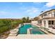 Backyard pool and spa with lush greenery and fountain features at 11453 Glowing Sunset Ln, Las Vegas, NV 89135
